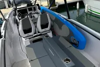 2022 Axopar 22 T-Top boat interior with seating and control panel at marina.