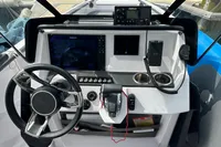 2022 Axopar 22 T-Top boat dashboard with steering wheel, controls, and navigation equipment.