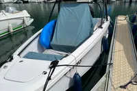 2022 Axopar 22 T-Top boat docked with protective cover and blue fenders.