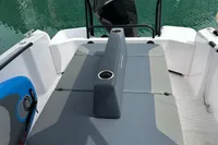 2022 Axopar 22 T-Top boat interior with cushioned seating and cup holders.