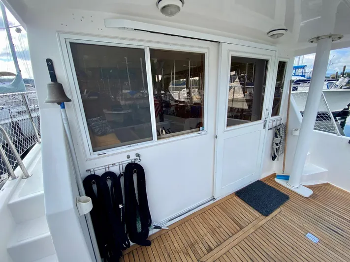 First Light Yacht Photos Pics 1999 Ocean Alexander 510 Pilothouse, aft deck with wood flooring and sliding doors.