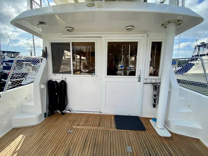 First Light Yacht Photos Pics Ocean Alexander 510 Pilothouse 1999, yacht stern view with wooden deck and glass doors.