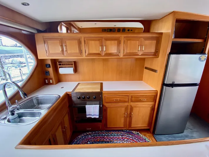 First Light Yacht Photos Pics 1999 Ocean Alexander 510 Pilothouse kitchen interior with wood cabinetry.