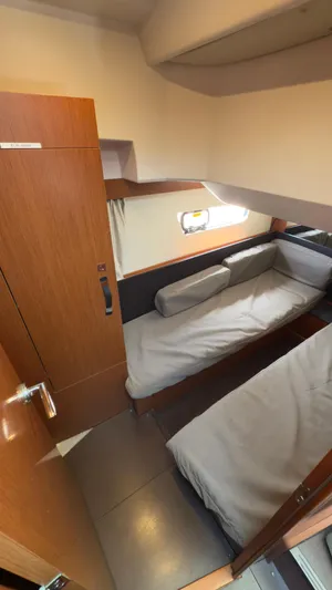  Yacht Photos Pics 2016 Jeanneau Velasco 37F cabin interior with twin beds and wooden finish.