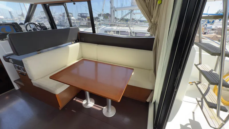  Yacht Photos Pics Interior of 2016 Jeanneau Velasco 37F with dining area and helm station.