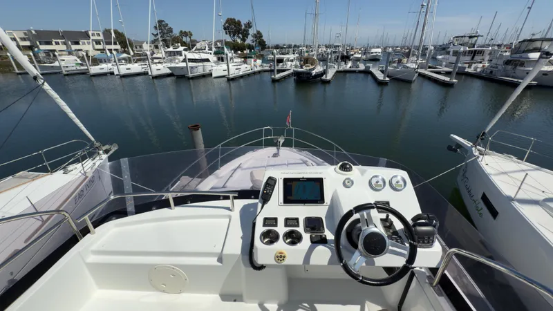  Yacht Photos Pics Flybridge view of 2016 Jeanneau Velasco 37F yacht docked in a marina.