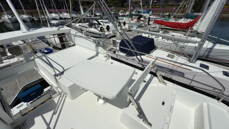  Yacht Photos Pics 2016 Jeanneau Velasco 37F yacht deck with seating, docked among other boats.
