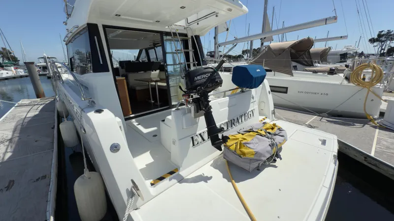  Yacht Photos Pics 2016 Jeanneau Velasco 37F yacht docked at marina, rear view with outboard motor.