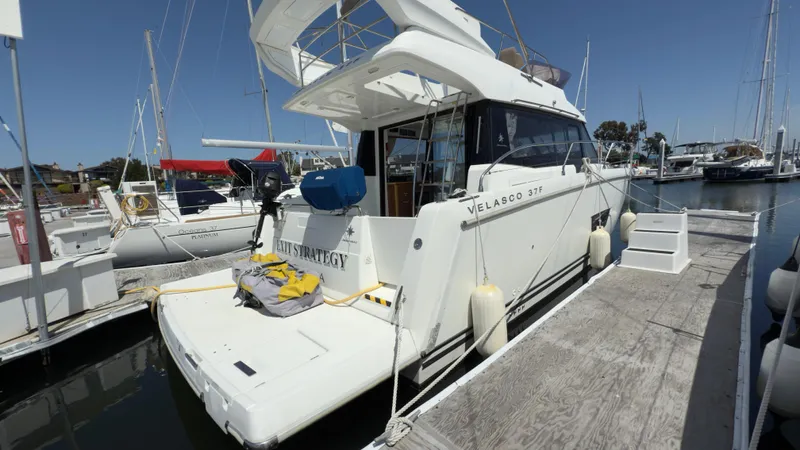  Yacht Photos Pics 2016 Jeanneau Velasco 37F docked at marina, rear view with clear sky.