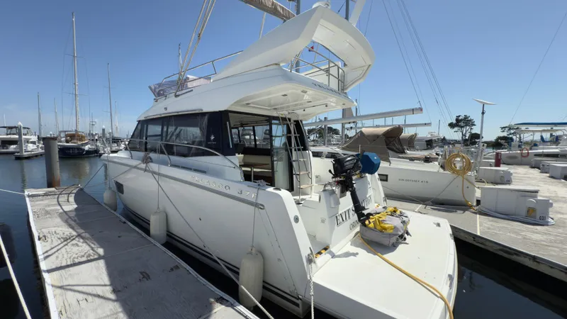 Yacht Photos Pics 2016 Jeanneau Velasco 37F yacht docked at marina under clear blue sky.
