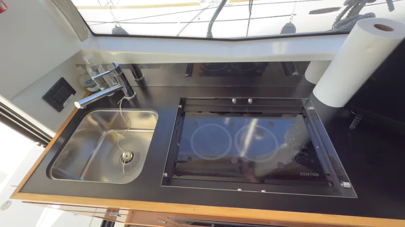  Yacht Photos Pics Modern kitchen area in 2016 Jeanneau Velasco 37F yacht with sink and stove.