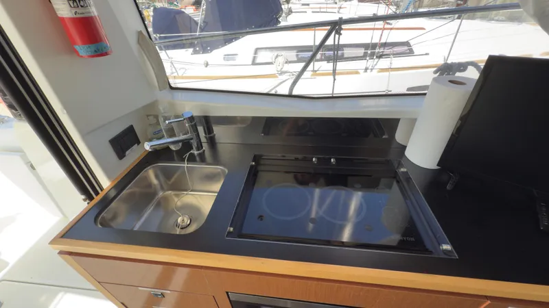  Yacht Photos Pics Jeanneau Velasco 37F 2016 yacht kitchen with sink and stove, featuring modern design.
