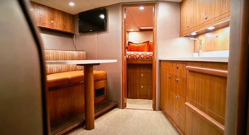 Jet Stream Yacht Photos Pics 2018 Spencer Yachts JET BOAT interior with dining area, kitchen, and bedroom.