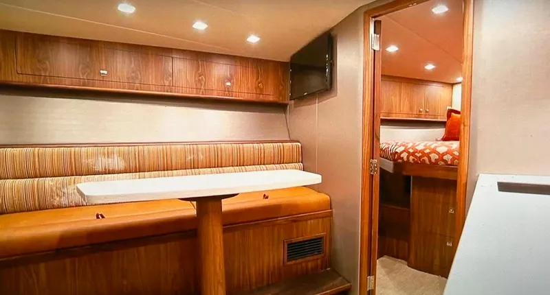 Jet Stream Yacht Photos Pics 2018 Spencer Yachts JET BOAT interior with dining area and cozy bedroom.