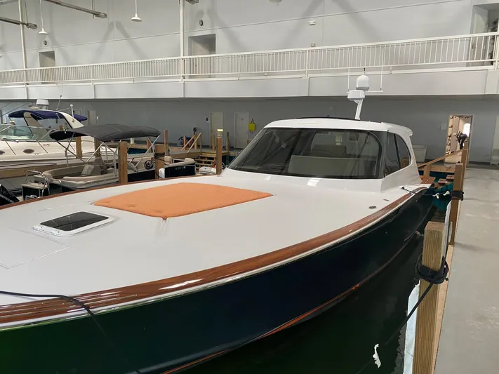 Jet Stream Yacht Photos Pics 2018 Spencer Yachts JET BOAT in indoor marina, sleek design, white and green hull.