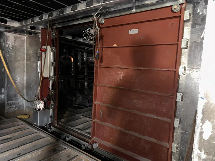  Yacht Photos Pics Engine room door of 2026 Trinity Yachts Custom T052, showcasing industrial design.