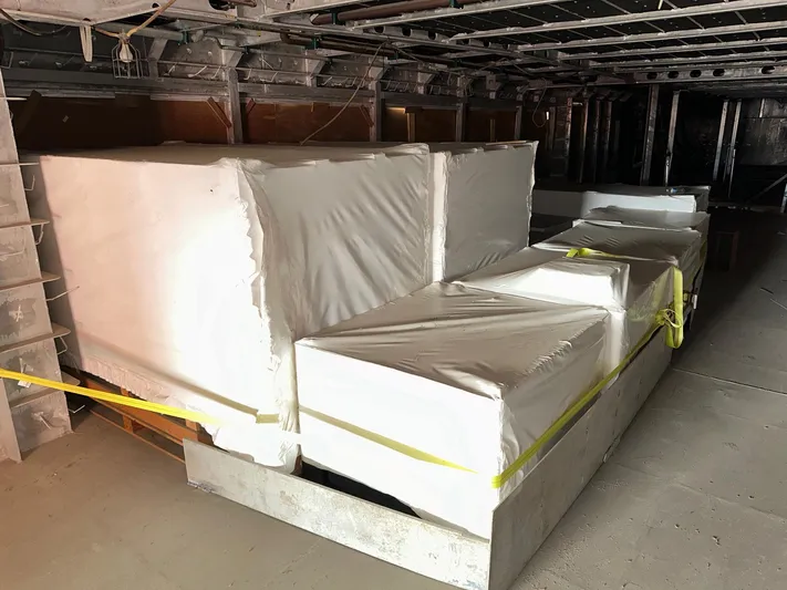  Yacht Photos Pics Interior of 2026 Trinity Yachts Custom T052, featuring wrapped equipment in storage area.