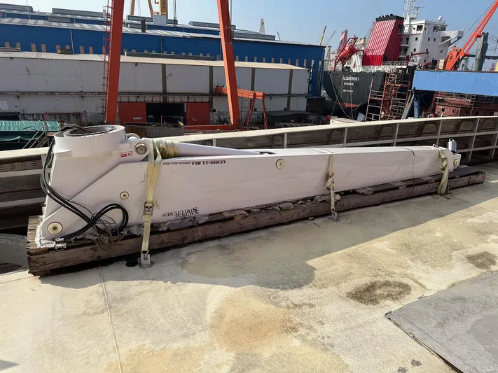  Yacht Photos Pics 2026 Trinity Yachts Custom T052 component on dock, surrounded by industrial equipment.