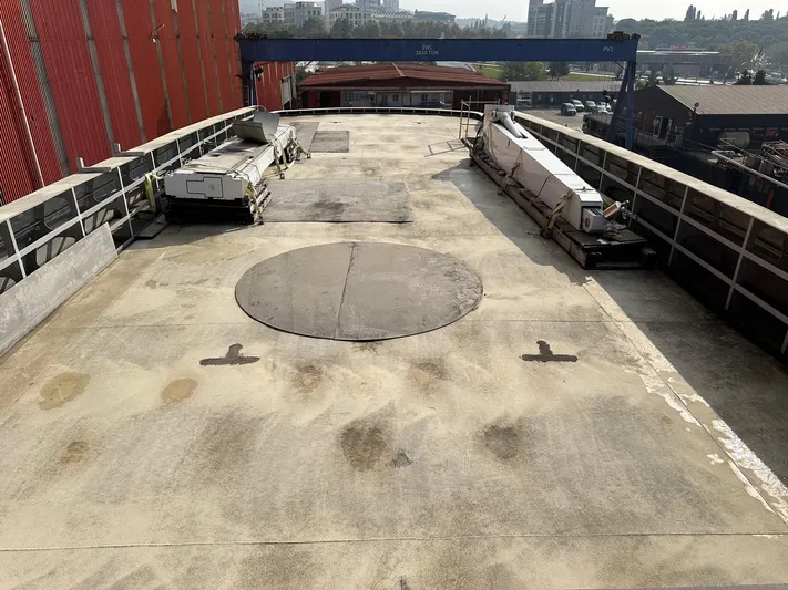  Yacht Photos Pics Deck of 2026 Trinity Yachts Custom T052, featuring spacious layout and industrial surroundings.