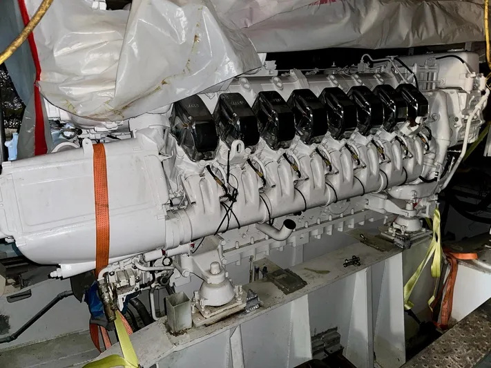  Yacht Photos Pics Engine of 2026 Trinity Yachts Custom T052, secured with straps, in a workshop setting.