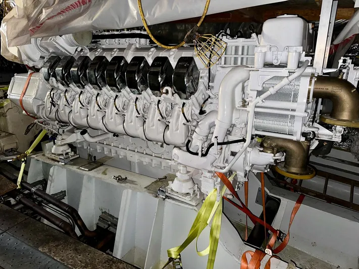  Yacht Photos Pics Engine room of 2026 Trinity Yachts Custom T052, featuring a large, white marine engine.