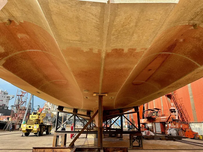  Yacht Photos Pics Underneath view of 2026 Trinity Yachts Custom T052 in a shipyard setting.