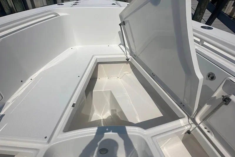 Pebbles Yacht Photos Pics Open storage compartment on 2008 Everglades 350 CC boat deck.
