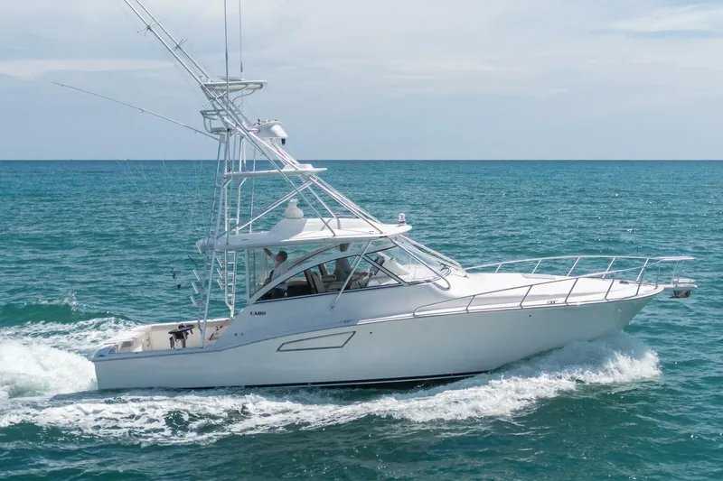 Big Hit Yacht Photos Pics 2020 Cabo 40 Express yacht cruising on open sea under clear skies.