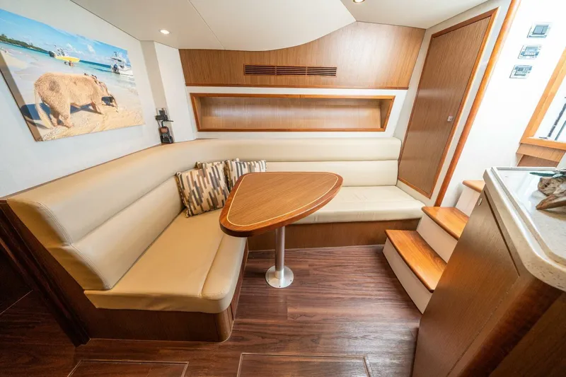 Big Hit Yacht Photos Pics Interior of 2020 Cabo 40 Express yacht with cozy seating and wooden accents.