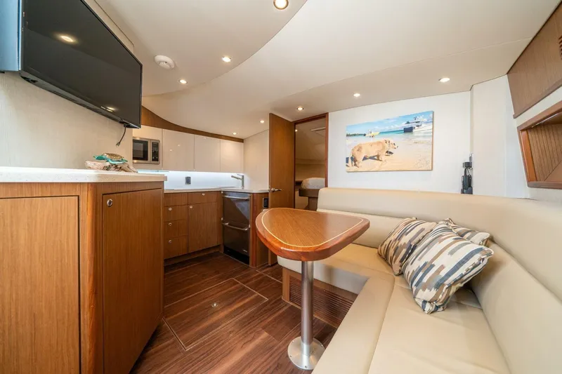 Big Hit Yacht Photos Pics Luxurious interior of 2020 Cabo 40 Express yacht with modern kitchen and cozy seating area.