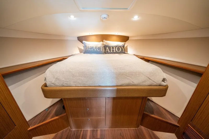 Big Hit Yacht Photos Pics Luxurious cabin interior of 2020 Cabo 40 Express yacht with cozy bedding.