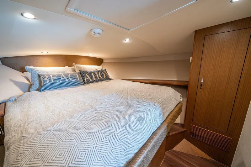 Big Hit Yacht Photos Pics Luxurious cabin interior of 2020 Cabo 40 Express yacht with cozy bedding.