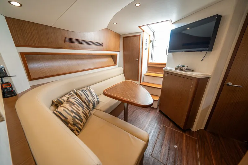 Big Hit Yacht Photos Pics Luxurious interior of 2020 Cabo 40 Express yacht with seating, table, and TV.