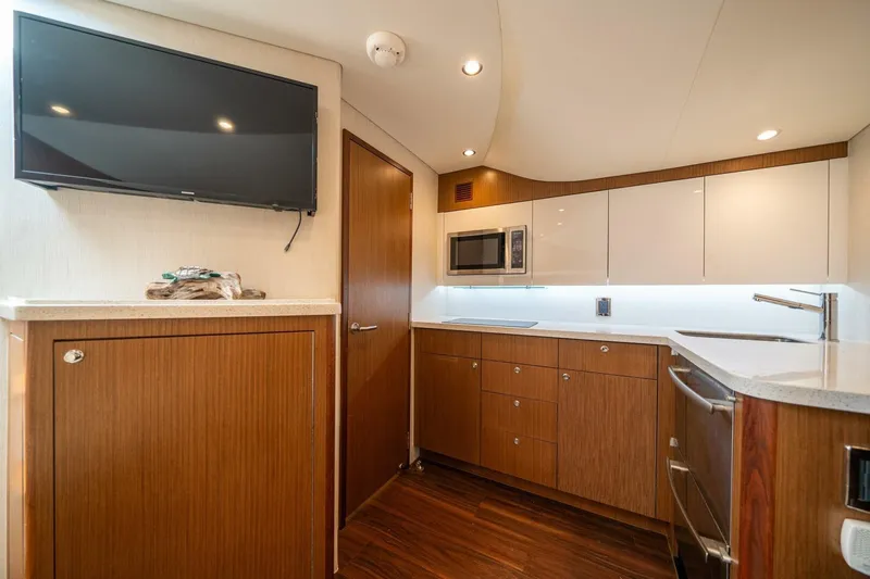 Big Hit Yacht Photos Pics Luxurious 2020 Cabo 40 Express yacht interior with modern kitchen and sleek cabinetry.