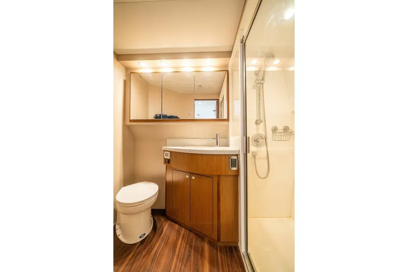 Big Hit Yacht Photos Pics Luxurious bathroom in 2020 Cabo 40 Express yacht with modern fixtures and wooden cabinetry.