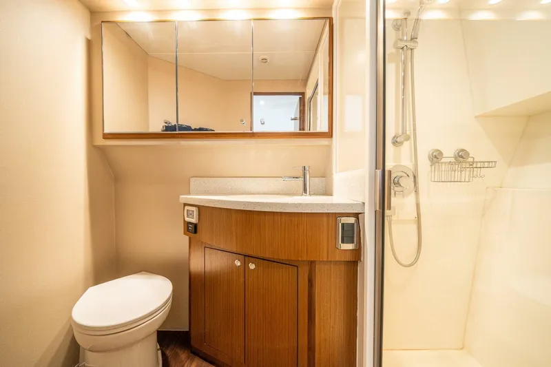 Big Hit Yacht Photos Pics Luxurious bathroom in 2020 Cabo 40 Express yacht with modern fixtures and wooden cabinetry.