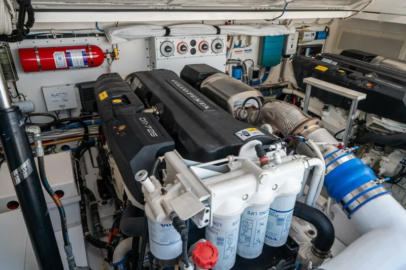 Big Hit Yacht Photos Pics Engine room of 2020 Cabo 40 Express boat with Volvo Penta engines and fire extinguisher.