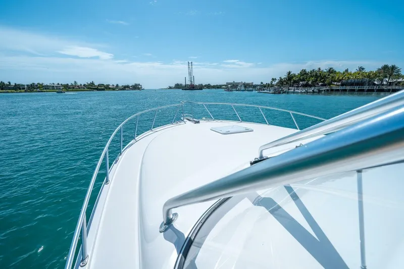 Big Hit Yacht Photos Pics Bow view of 2020 Cabo 40 Express yacht cruising on a sunny day.