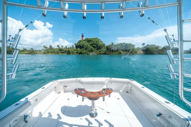 Big Hit Yacht Photos Pics Cabo 40 Express 2020 yacht with scenic ocean view and distant lighthouse.