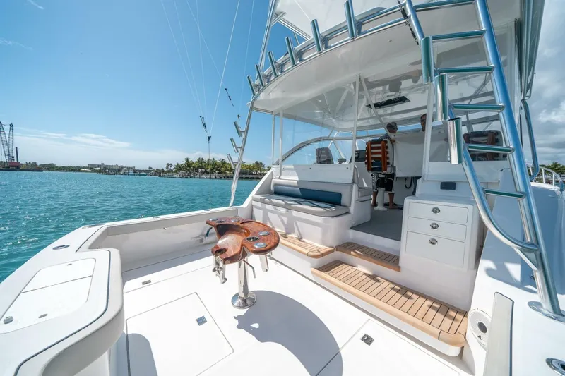 Big Hit Yacht Photos Pics 2020 Cabo 40 Express yacht with spacious deck and fishing chair on sunny day.