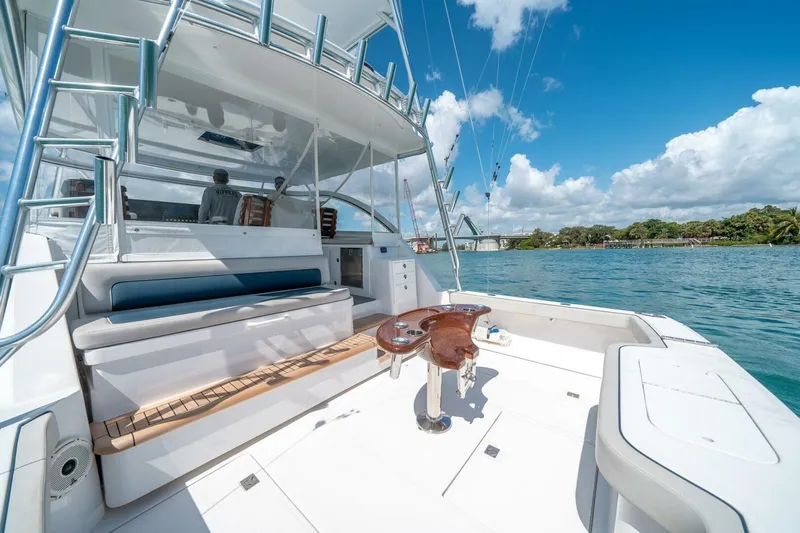 Big Hit Yacht Photos Pics 2020 Cabo 40 Express yacht with spacious deck, blue skies, and scenic waterway.