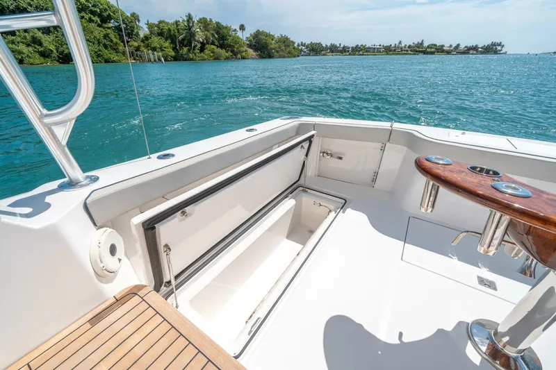 Big Hit Yacht Photos Pics 2020 Cabo 40 Express yacht deck with open storage, overlooking serene blue waters.