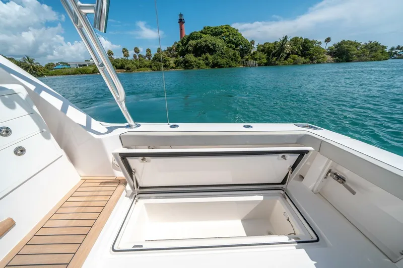 Big Hit Yacht Photos Pics Cabo 40 Express 2020 boat with open storage compartment, scenic water view.