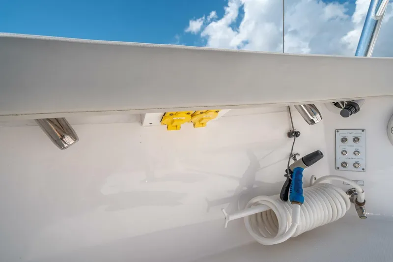 Big Hit Yacht Photos Pics Cabo 40 Express 2020 boat deck with coiled hose and control panel under blue sky.