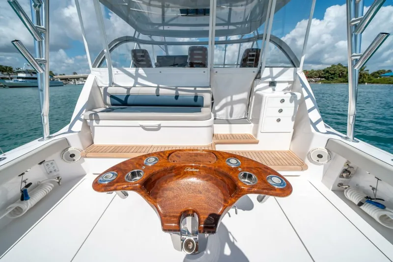 Big Hit Yacht Photos Pics 2020 Cabo 40 Express yacht deck with wooden table, ocean view, and seating area.