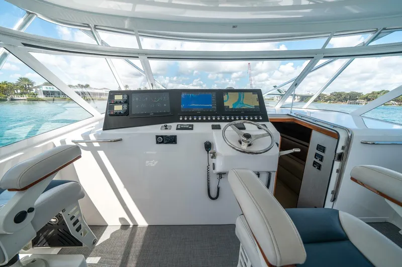 Big Hit Yacht Photos Pics 2020 Cabo 40 Express yacht helm with modern navigation equipment and panoramic windows.