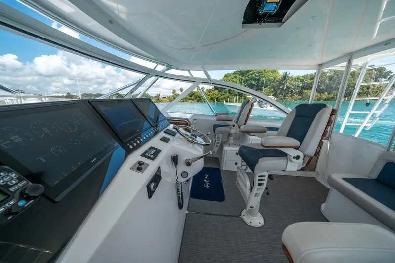 Big Hit Yacht Photos Pics 2020 Cabo 40 Express yacht cockpit with modern navigation equipment and luxurious seating.