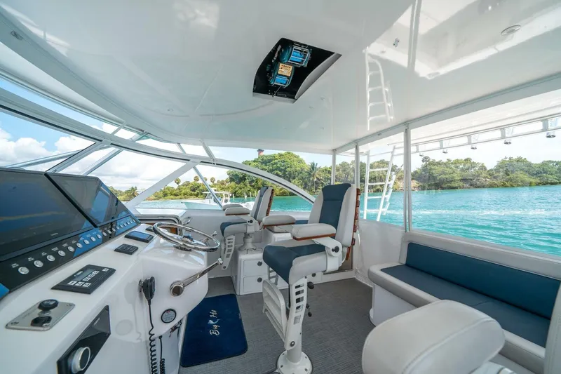 Big Hit Yacht Photos Pics 2020 Cabo 40 Express yacht interior with modern helm, seating, and scenic water view.