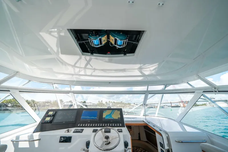 Big Hit Yacht Photos Pics Helm of 2020 Cabo 40 Express yacht with navigation screens and steering wheel.