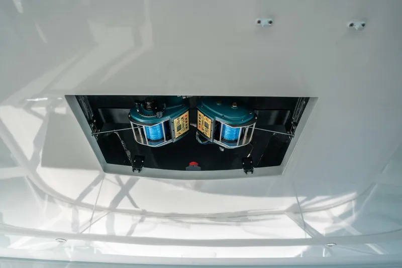 Big Hit Yacht Photos Pics Fishing equipment on 2020 Cabo 40 Express boat, featuring dual reels in a compartment.